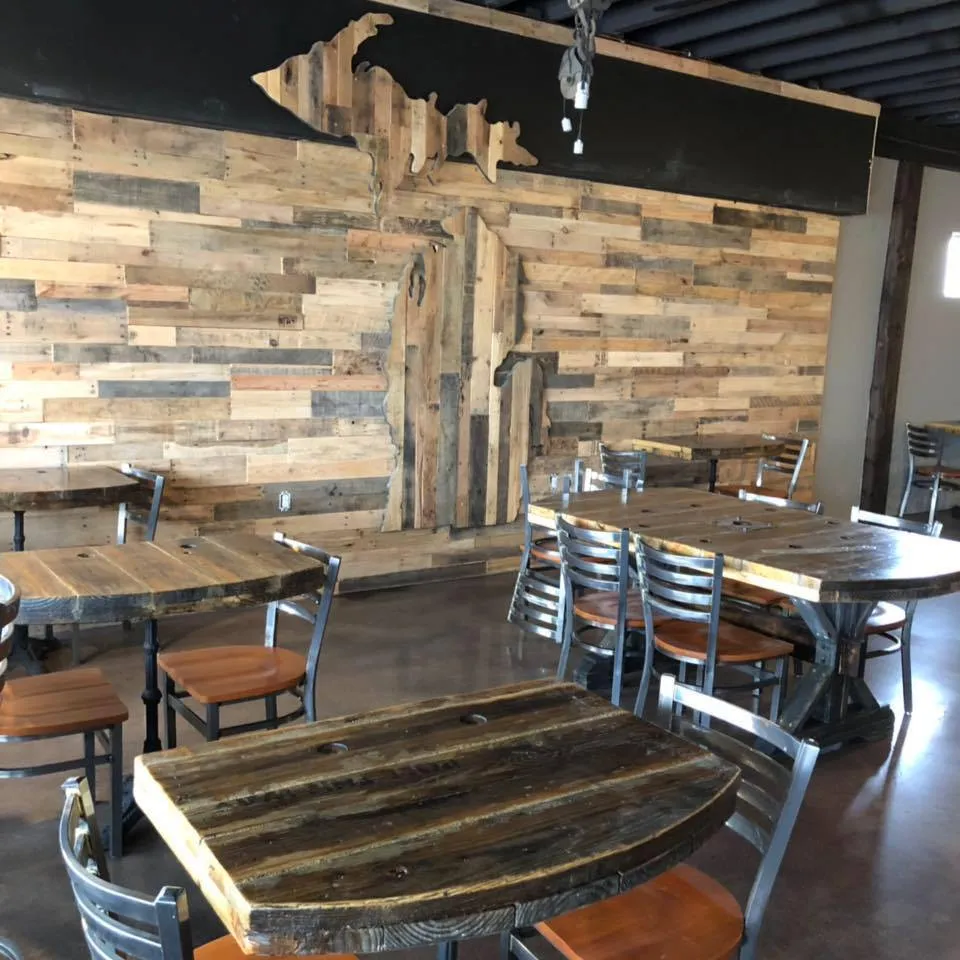 Reclaimed wood tables and the Michigan wall inside The Room